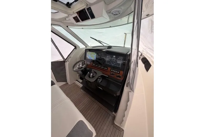Slide: The Image of 2021 Tiara Sport 38 LS boat cockpit with modern navigation system and steering wheel. - 15