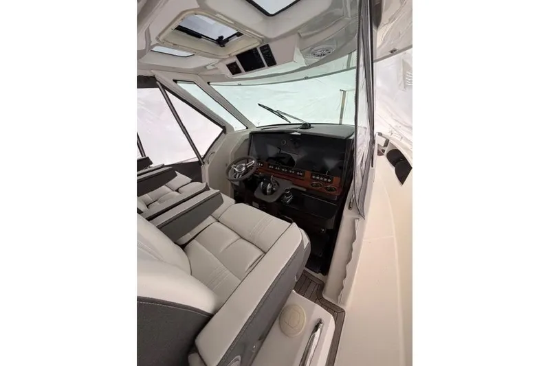 Slide: The Image of Interior of 2021 Tiara Sport 38 LS boat, featuring modern helm and seating. - 16