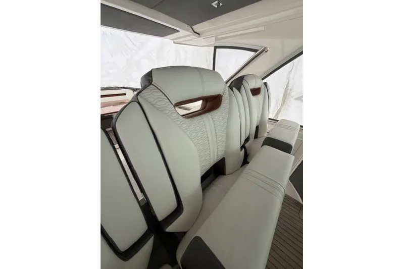 Slide: The Image of Luxurious interior seating of 2021 Tiara Sport 38 LS boat, featuring elegant white upholstery. - 19