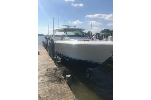 Slide: The Image of 2021 Tiara Sport 38 LS boat docked on a sunny day. - 2