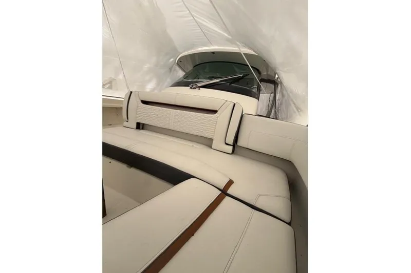 Slide: The Image of 2021 Tiara Sport 38 LS boat interior with white seating and protective cover. - 23