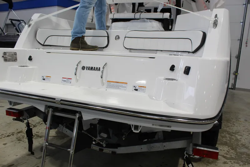 Slide: The Image of 2025 Yamaha Boats 222 FSH Sport E, rear view with swim platform and ladder. - 2