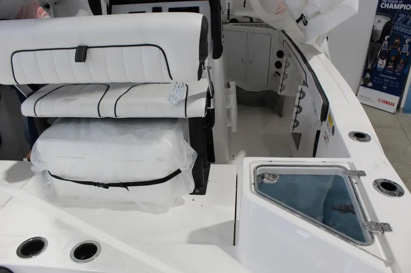 Slide: The Image of 2025 Yamaha Boats 222 FSH Sport E interior with seating and storage compartments. - 3