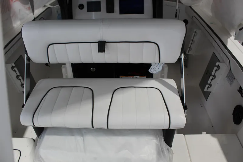 Slide: The Image of 2025 Yamaha Boats 222 FSH Sport E interior seating, featuring white cushioned seats. - 5