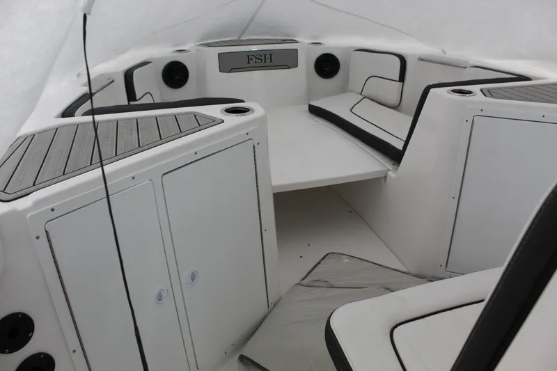 Slide: The Image of 2025 Yamaha Boats 222 FSH Sport E interior with seating and storage compartments. - 8