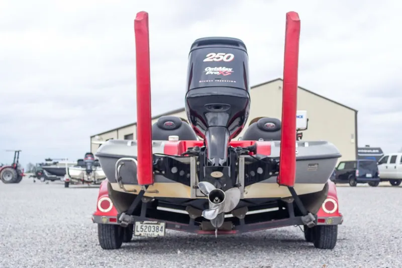 Slide: The Image of 2009 Ranger Z520 Comanche boat with Optimax Pro XS engine, parked on gravel. - 10