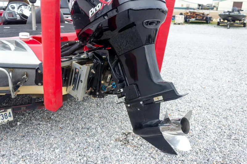Slide: The Image of 2009 Ranger Z520 Comanche boat motor with red accents on gravel surface. - 23