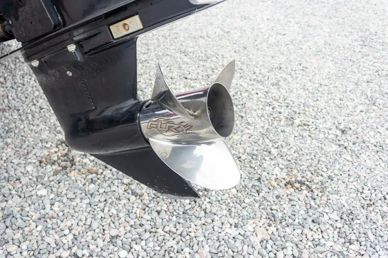 Slide: The Image of 2009 Ranger Z520 Comanche boat propeller on gravel surface. - 24