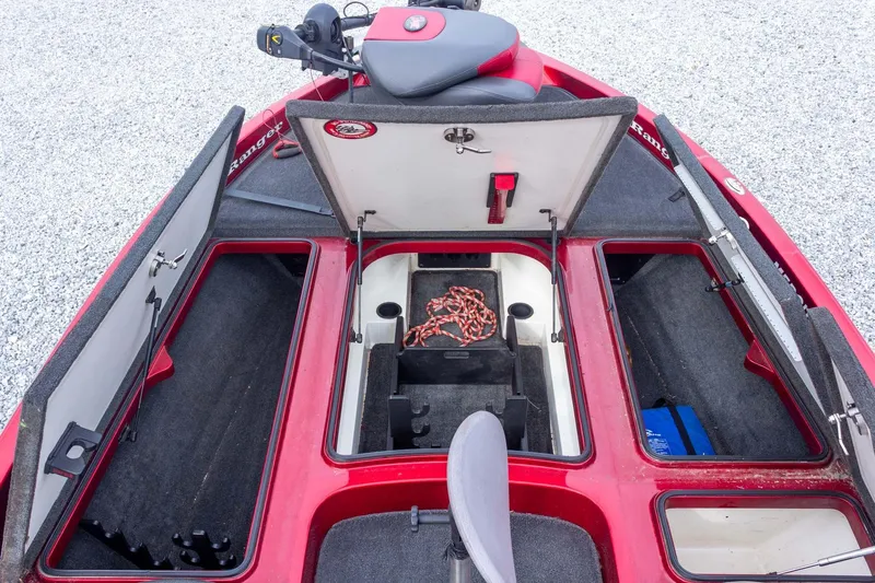 Slide: The Image of 2009 Ranger Z520 Comanche boat interior with open storage compartments and red accents. - 29