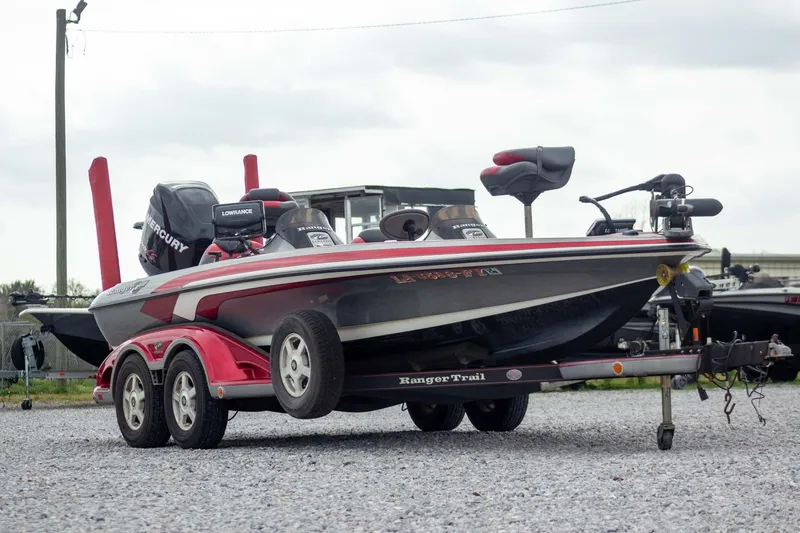 Slide: The Image of 2009 Ranger Z520 Comanche bass boat on trailer, featuring Mercury engine and Lowrance electronics. - 3
