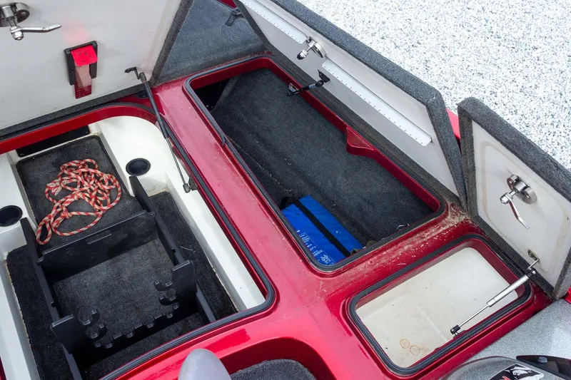 Slide: The Image of 2009 Ranger Z520 Comanche boat storage compartments with open lids and visible rope. - 30