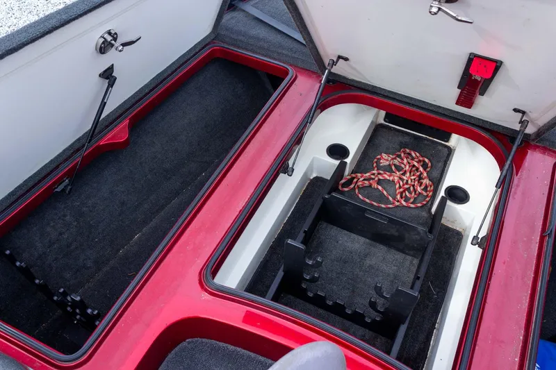 Slide: The Image of 2009 Ranger Z520 Comanche boat storage compartments with red trim and rope. - 31