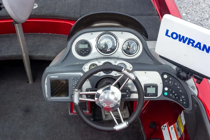 Slide: The Image of 2009 Ranger Z520 Comanche boat dashboard with steering wheel and Lowrance electronics. - 37