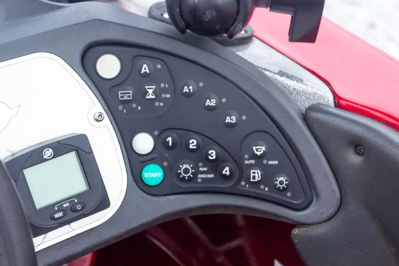 Slide: The Image of Control panel of a 2009 Ranger Z520 Comanche boat with various buttons and display. - 38