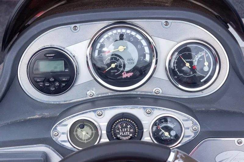 Slide: The Image of Dashboard of a 2009 Ranger Z520 Comanche boat with gauges and controls. - 39