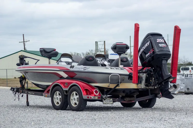 Slide: The Image of 2009 Ranger Z520 Comanche boat with Mercury engine on trailer, parked outdoors. - 4