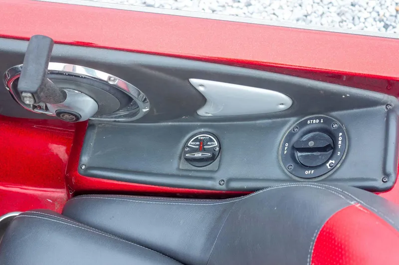 Slide: The Image of 2009 Ranger Z520 Comanche boat control panel with switches and levers. - 40