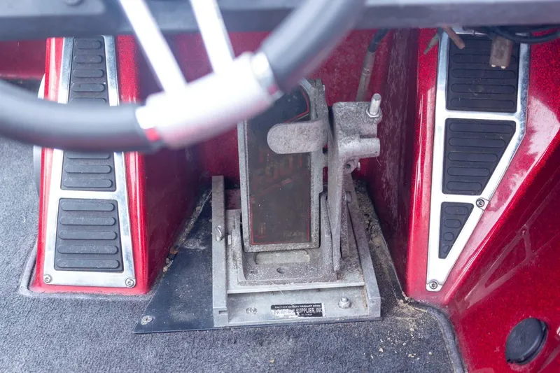 Slide: The Image of 2009 Ranger Z520 Comanche boat foot pedal controls with red and black accents. - 41