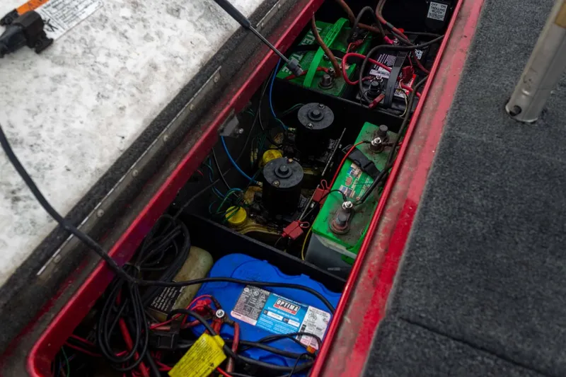 Slide: The Image of 2009 Ranger Z520 Comanche boat battery compartment with wiring and components. - 44