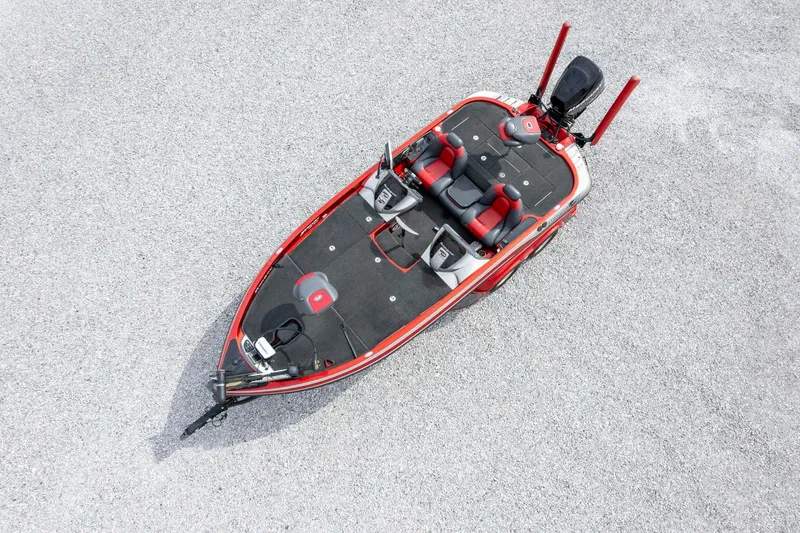 Slide: The Image of 2009 Ranger Z520 Comanche boat, aerial view, red and black design, on gravel surface. - 48
