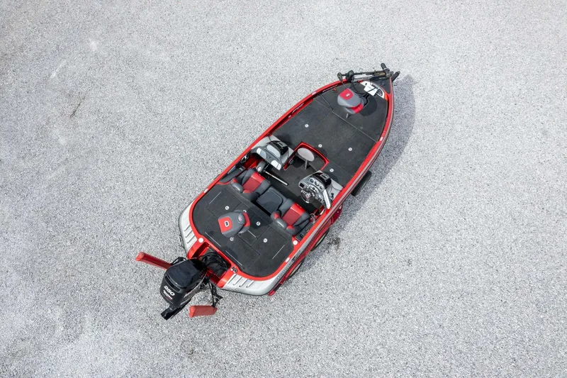 Slide: The Image of 2009 Ranger Z520 Comanche boat, aerial view, red and black design, parked on gravel surface. - 52