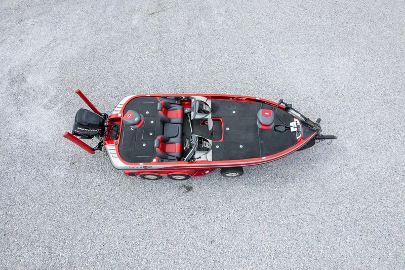Slide: The Image of 2009 Ranger Z520 Comanche boat, aerial view, red and black design, parked on gravel. - 53