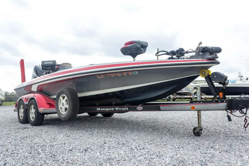 Slide: The Image of 2009 Ranger Z520 Comanche bass boat on trailer, parked on gravel. - 7