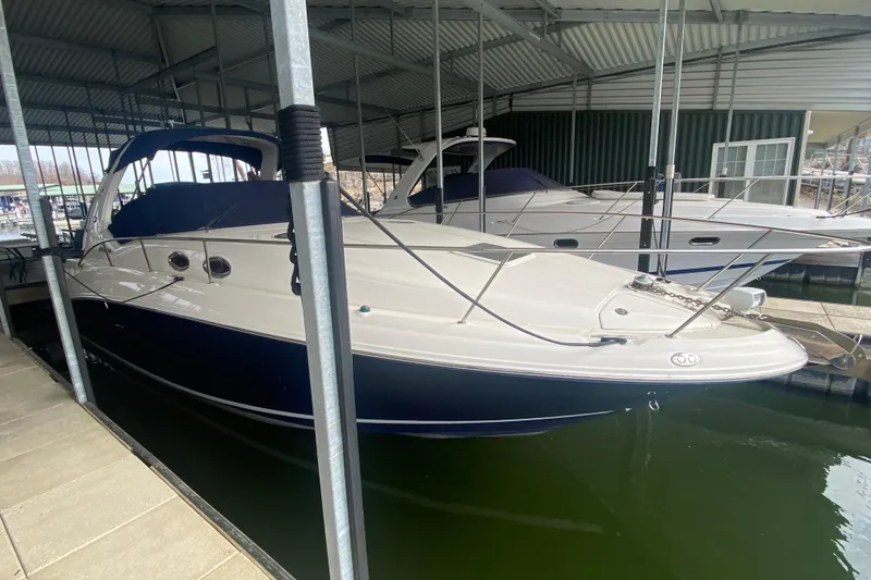 Slide: The Image of 2004 Sea Ray Sundancer 320 docked in a covered marina. - 12
