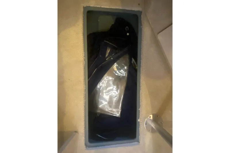 Slide: The Image of Storage compartment on a 2004 Sea Ray Sundancer 320 boat interior. - 13