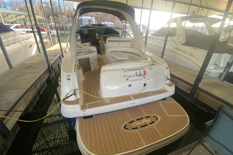 Slide: The Image of 2004 Sea Ray Sundancer 320 docked in a marina, rear view. - 14