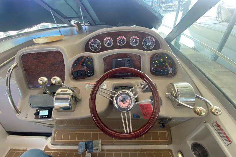 Slide: The Image of 2004 Sea Ray Sundancer 320 helm with gauges, controls, and steering wheel. - 22