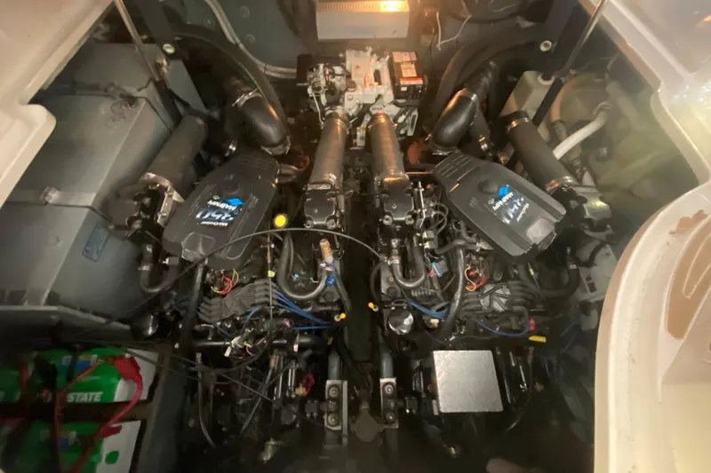 Slide: The Image of Engine compartment of a 2004 Sea Ray Sundancer 320, featuring dual inboard motors. - 26