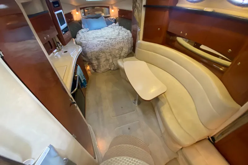 Slide: The Image of 2004 Sea Ray Sundancer 320 interior with cozy seating and sleeping area. - 29