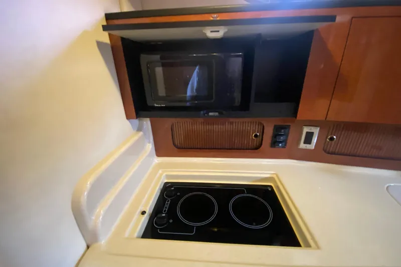 Slide: The Image of 2004 Sea Ray Sundancer 320 galley with microwave and electric stove. - 31