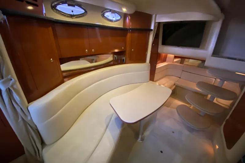 Slide: The Image of Luxurious interior of 2004 Sea Ray Sundancer 320 yacht with elegant seating and dining area. - 34
