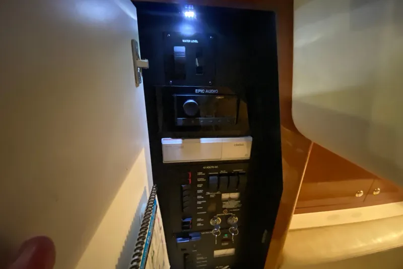 Slide: The Image of Control panel inside 2004 Sea Ray Sundancer 320 yacht, featuring audio and electrical systems. - 36
