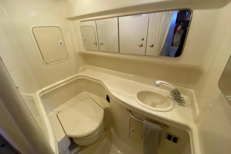 Slide: The Image of 2004 Sea Ray Sundancer 320 bathroom with sink, toilet, and mirrored cabinets. - 37