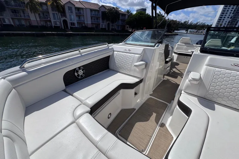 Slide: The Image of 2024 Sea Ray SDX 290 Outboard interior with luxurious seating and waterfront view. - 19