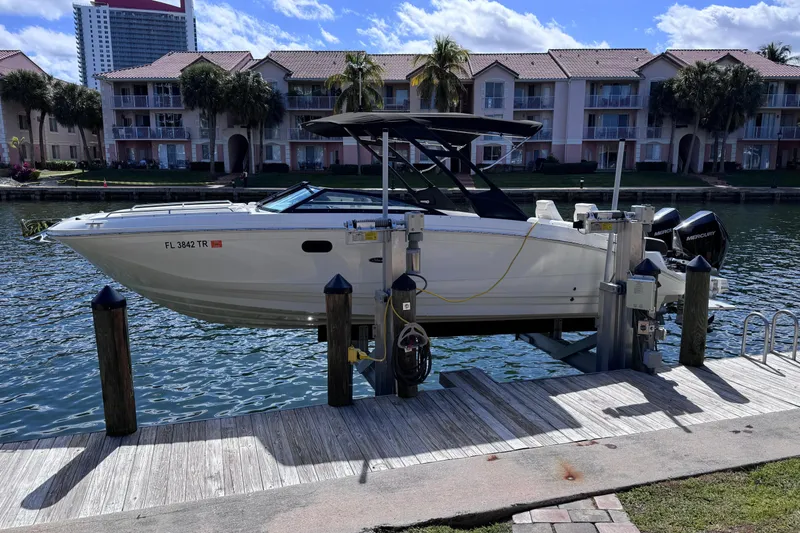 Slide: The Image of 2024 Sea Ray SDX 290 Outboard boat docked by waterfront homes. - 3