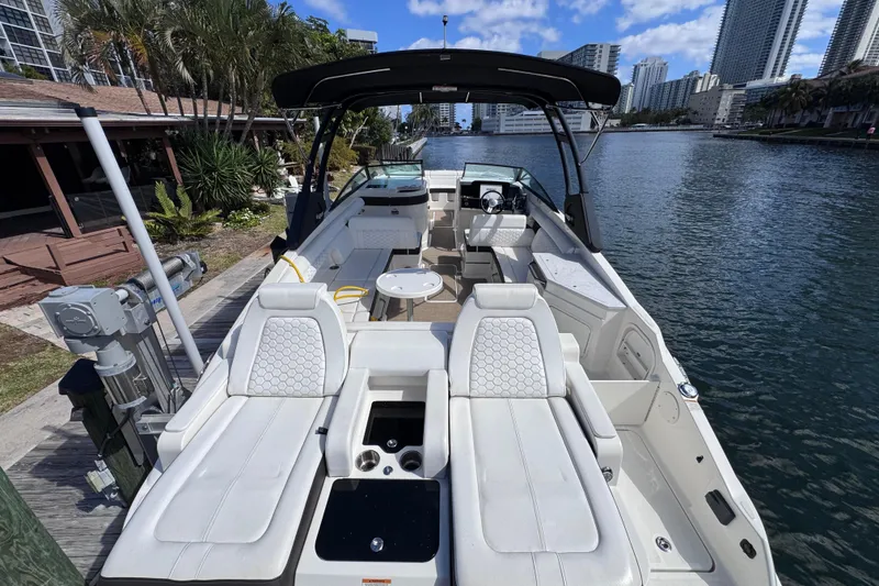 Slide: The Image of 2024 Sea Ray SDX 290 Outboard boat docked by waterfront, featuring luxurious seating and modern design. - 30