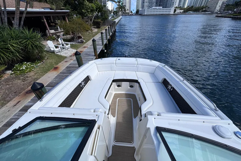 Slide: The Image of 2024 Sea Ray SDX 290 Outboard boat docked by waterfront, featuring spacious seating. - 32