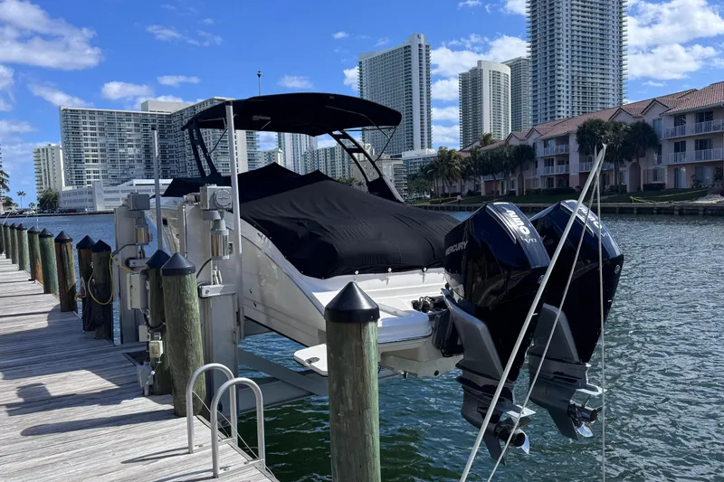 Slide: The Image of 2024 Sea Ray SDX 290 Outboard docked with cityscape background. - 4