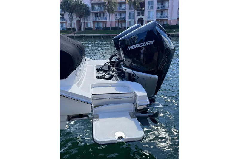 Slide: The Image of 2024 Sea Ray SDX 290 Outboard with Mercury engine, docked by waterfront buildings. - 6