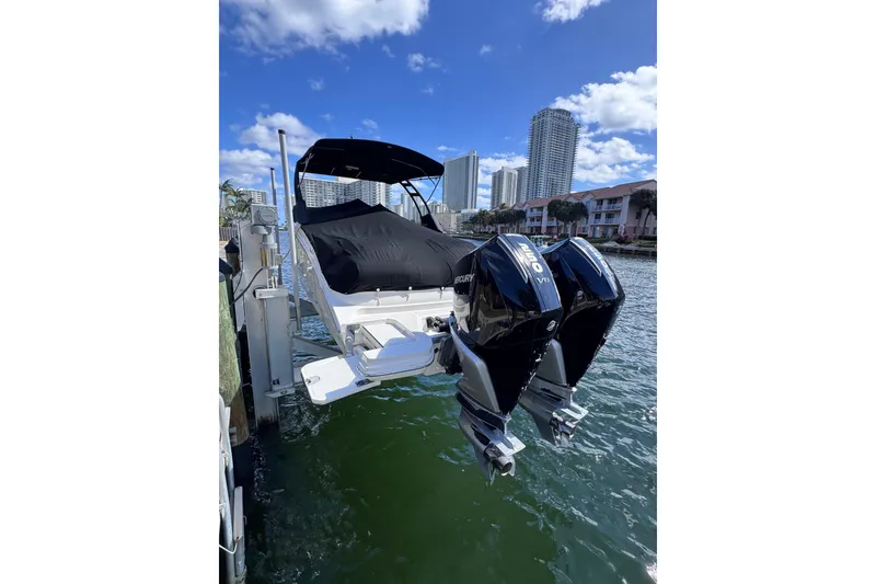 Slide: The Image of 2024 Sea Ray SDX 290 Outboard boat docked with twin Mercury engines. - 7