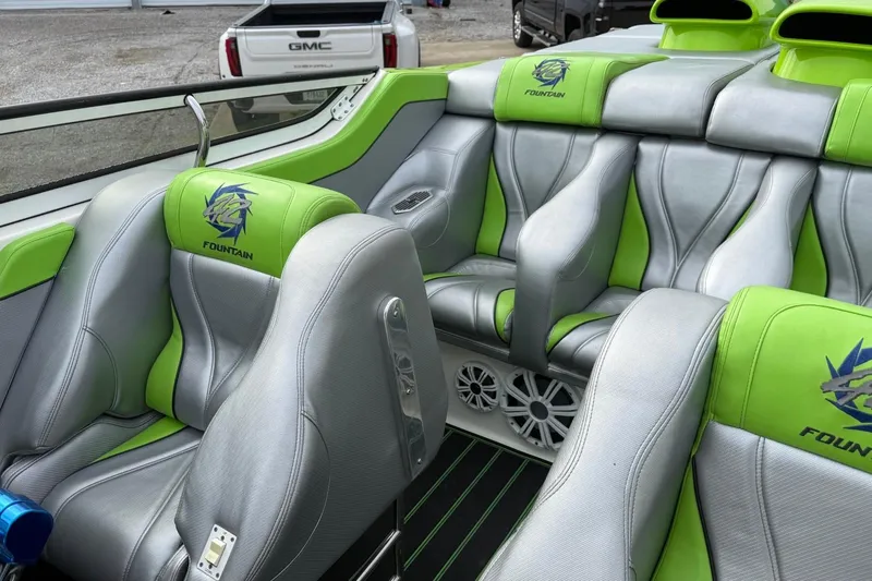 Slide: The Image of 2002 Fountain 42 Lightning boat interior with green and gray seating, featuring logo embroidery. - 10