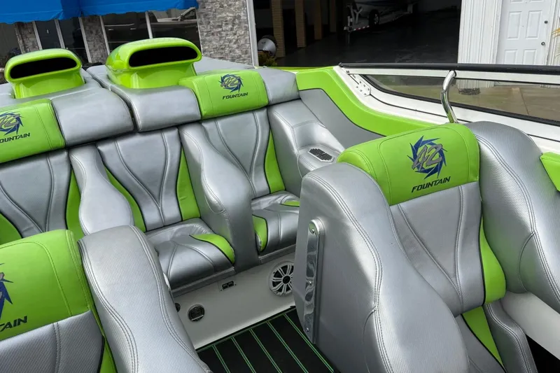 Slide: The Image of 2002 Fountain 42 Lightning boat interior with green and gray seating, featuring logo embroidery. - 11