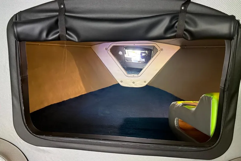 Slide: The Image of Interior cabin of 2002 Fountain 42 Lightning boat, featuring a compact, cozy space. - 17