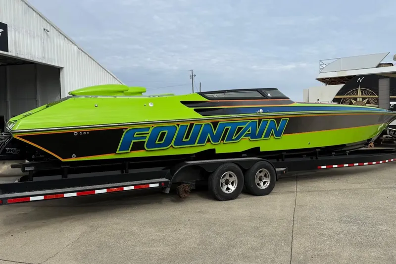 Slide: The Image of 2002 Fountain 42 Lightning speedboat in vibrant green on a trailer. - 6