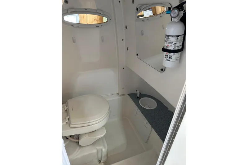 Slide: The Image of 2019 Sea Pro 239 Deep V CC boat interior with toilet and fire extinguisher. - 10