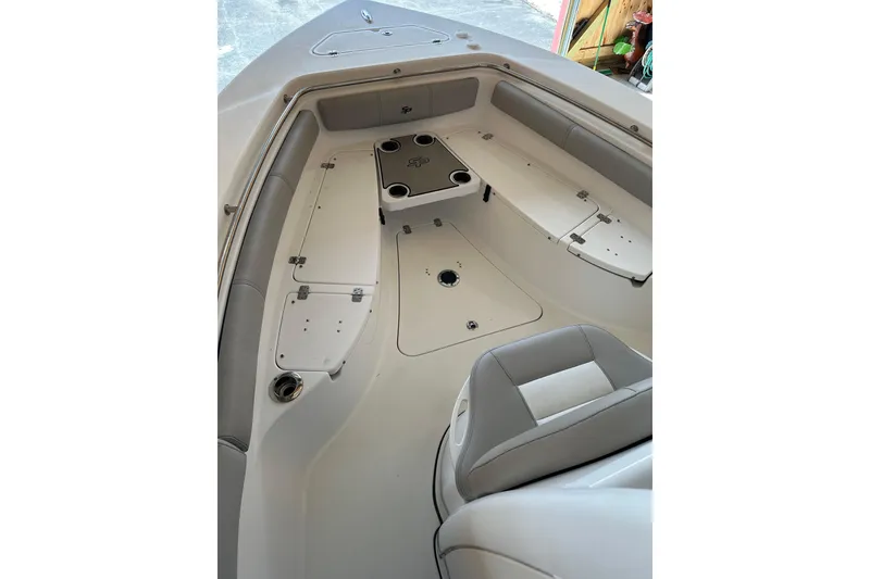 Slide: The Image of 2019 Sea Pro 239 Deep V CC boat interior with seating and storage compartments. - 11